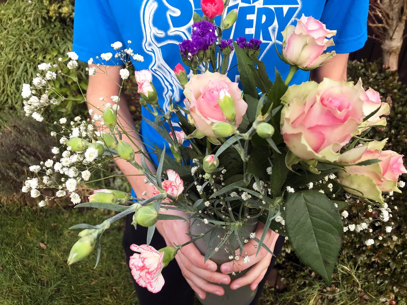 White and green bouquet of flowers in a vase for Mother's Day